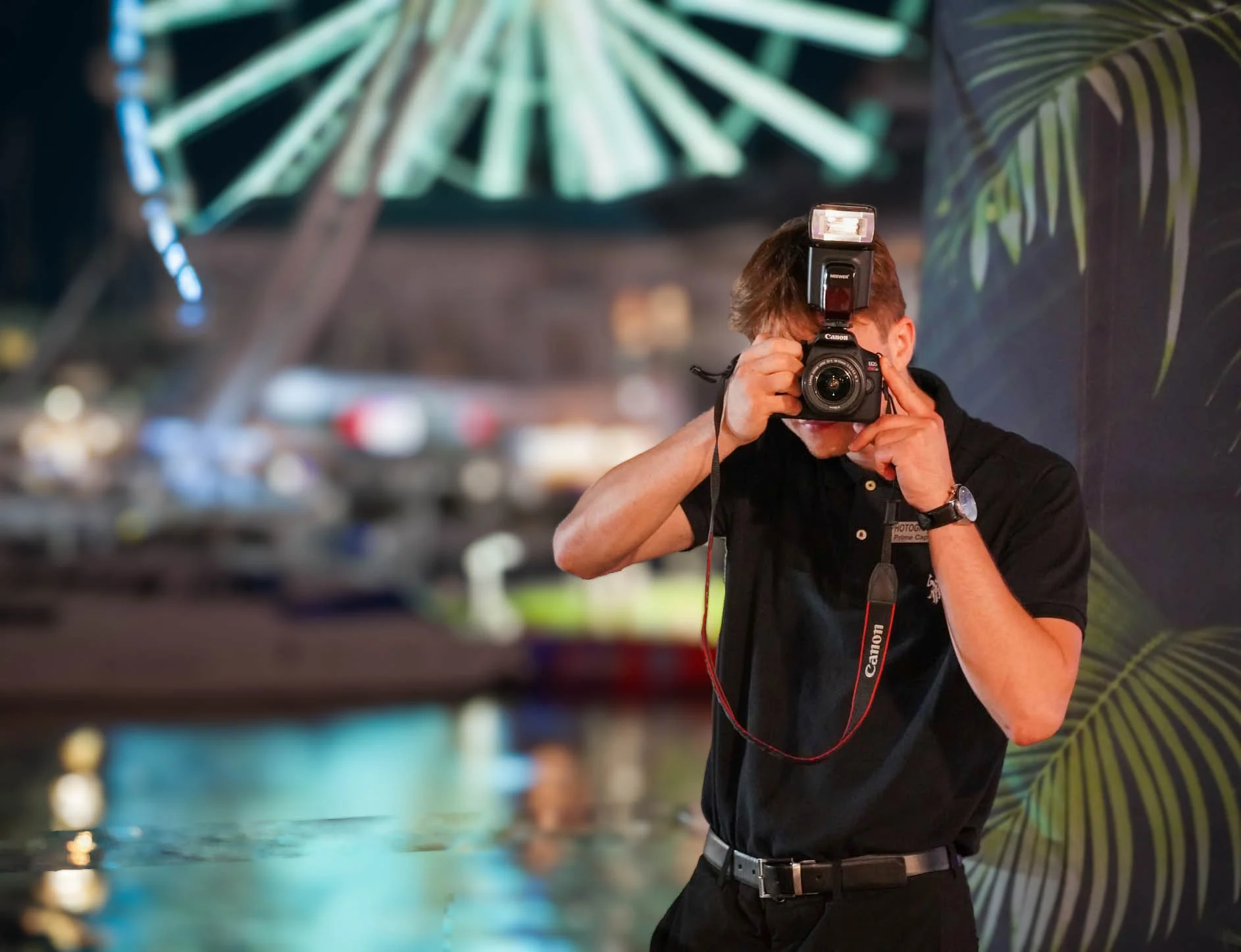 Photographer capturing a night out with a camera and flash